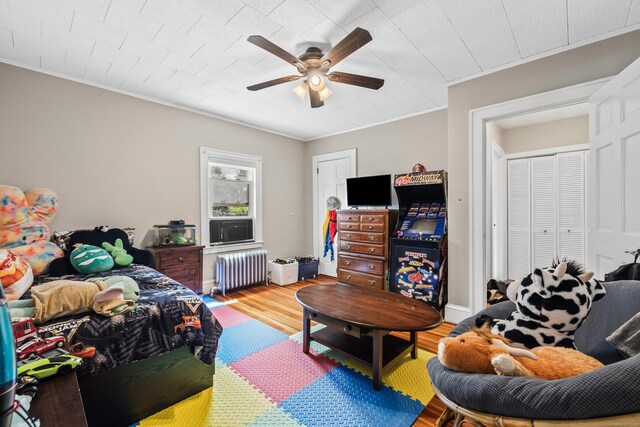 33 Hugh St, West Hartford, CT 06119 - living room with radiator heating unit, ceiling fan, ornamental molding, and wood finished floors