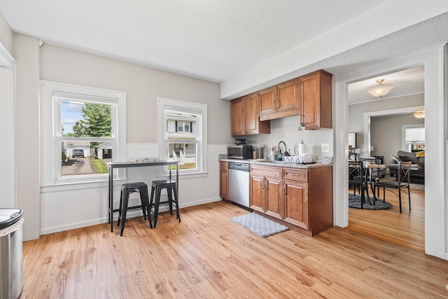 33 Hugh St, West Hartford, CT 06119 - kitchen with appliances with stainless steel finishes, brown cabinets, and light wood-style floors