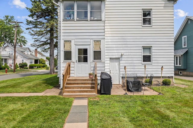33 Hugh St, West Hartford, CT 06119 - back of house featuring a lawn and a patio area
