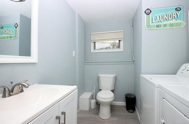 1357 Meriden Ave, Southington, CT 06489 - bathroom featuring separate washer and dryer, vanity, and wood finished floors