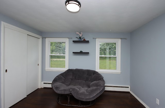 1357 Meriden Ave, Southington, CT 06489 - living area with a baseboard radiator, healthy amount of natural light, and wood finished floors