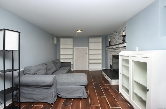 1357 Meriden Ave, Southington, CT 06489 - living area with dark wood-style flooring and a fireplace