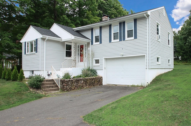 1357 Meriden Ave, Southington, CT 06489 - split level home featuring a chimney, a garage, a front lawn, and asphalt driveway