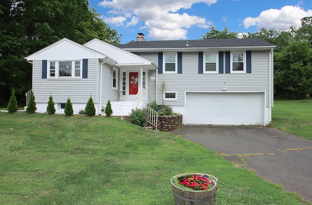 1357 Meriden Ave, Southington, CT 06489 - tri-level home featuring an attached garage, driveway, a chimney, and a front yard