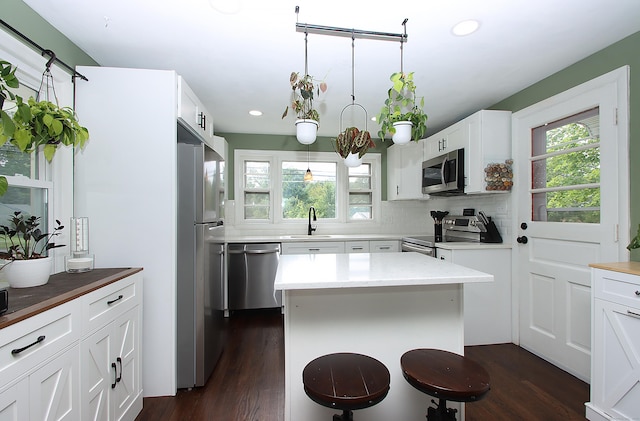 1357 Meriden Ave, Southington, CT 06489 - kitchen featuring stainless steel appliances, recessed lighting, dark wood-style flooring, backsplash, and white cabinets