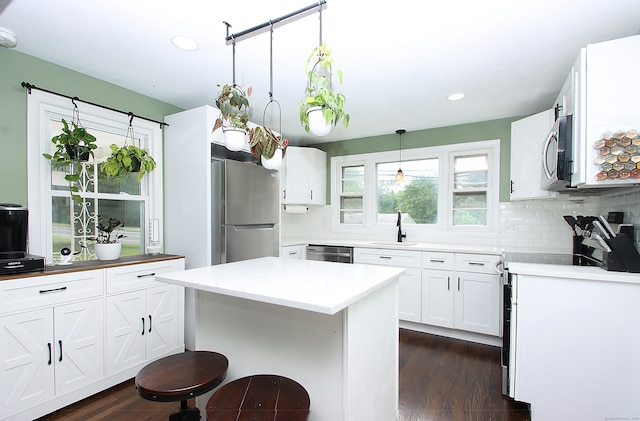 1357 Meriden Ave, Southington, CT 06489 - kitchen featuring appliances with stainless steel finishes, backsplash, recessed lighting, dark wood-style flooring, and white cabinetry