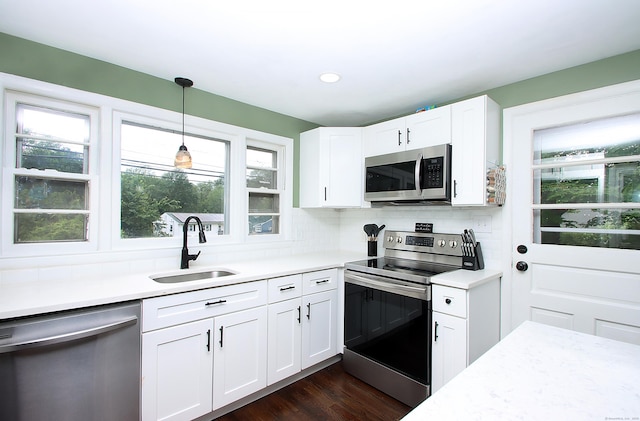 1357 Meriden Ave, Southington, CT 06489 - kitchen featuring appliances with stainless steel finishes, light countertops, hanging light fixtures, white cabinets, and recessed lighting