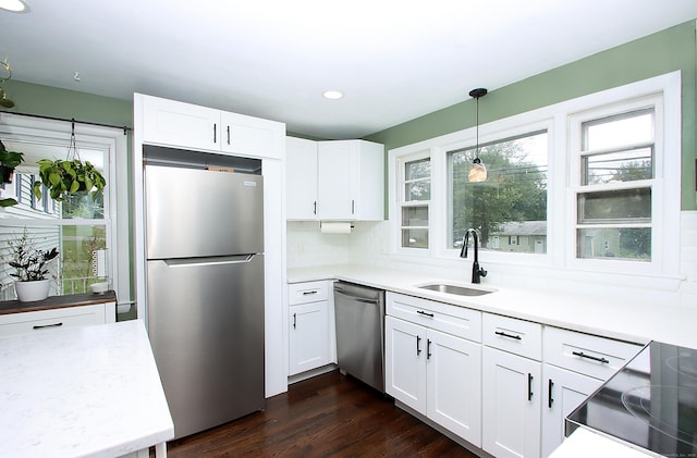 1357 Meriden Ave, Southington, CT 06489 - kitchen featuring appliances with stainless steel finishes, white cabinets, hanging light fixtures, light countertops, and recessed lighting