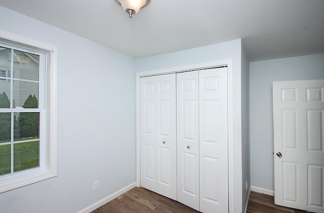 5 Golden Hill Ave, Danbury, CT 06811 - unfurnished bedroom with dark wood-style flooring, a closet, and multiple windows