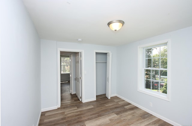 5 Golden Hill Ave, Danbury, CT 06811 - unfurnished bedroom featuring multiple windows, wood finished floors, and a closet