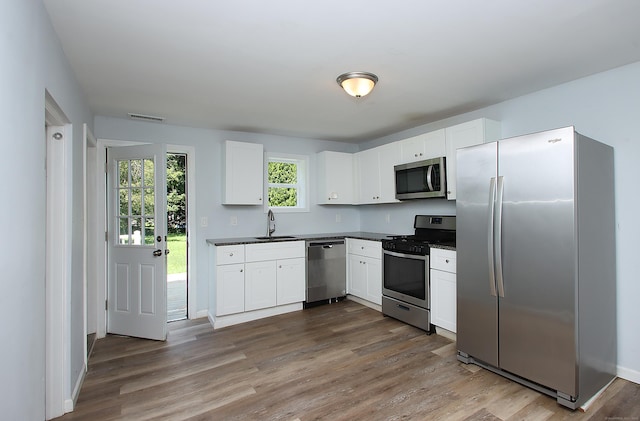 5 Golden Hill Ave, Danbury, CT 06811 - kitchen with appliances with stainless steel finishes, dark countertops, dark wood-style flooring, and white cabinetry