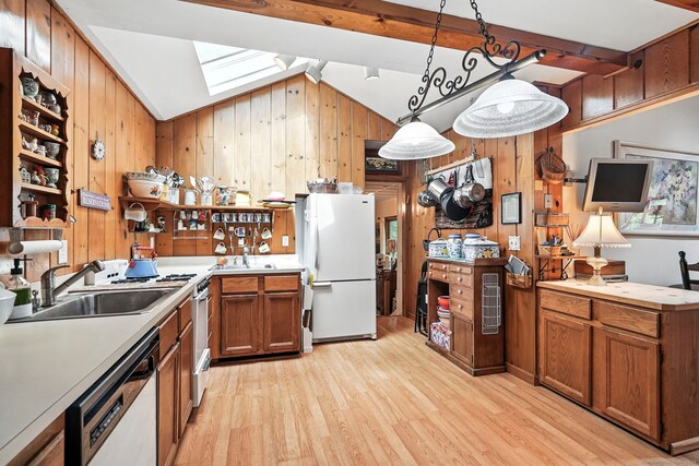 29 Carol St, Danbury, CT 06810 - kitchen with white appliances, wood walls, a skylight, light wood-style floors, and brown cabinetry