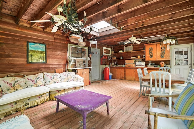 29 Carol St, Danbury, CT 06810 - living area featuring a ceiling fan, wooden walls, a skylight, wood-type flooring, and a wood ceiling with exposed beams