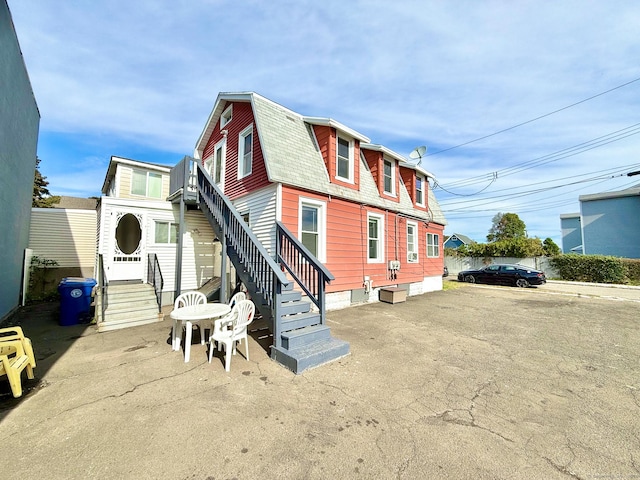 12 Arlington St, West Haven, CT 06516 - back of house featuring a gambrel roof, stairs, and a shingled roof