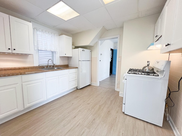 12 Arlington St, West Haven, CT 06516 - kitchen with white appliances, a drop ceiling, light wood-style floors, white cabinetry, and dark countertops