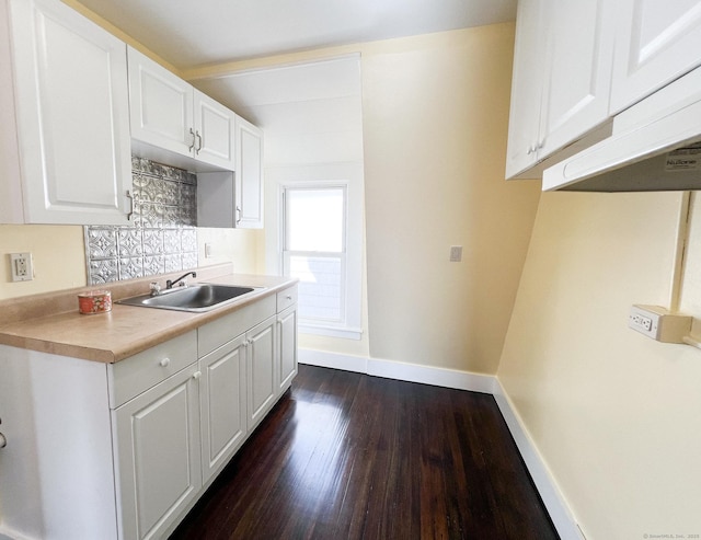 12 Arlington St, West Haven, CT 06516 - kitchen with dark wood finished floors, white cabinets, light countertops, and decorative backsplash
