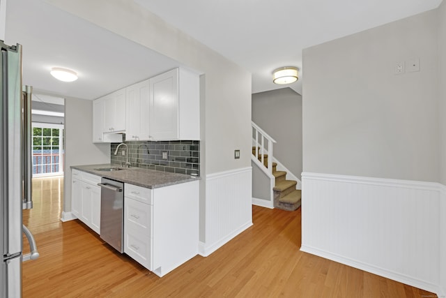97 Park Ave Unit 70, Danbury, CT 06810 - kitchen with dishwasher, light wood-style flooring, wainscoting, white cabinetry, and dark stone countertops