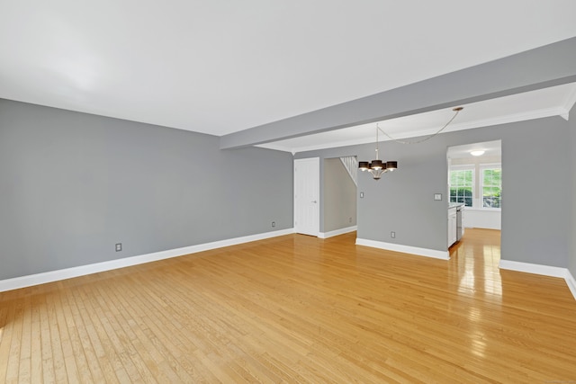 97 Park Ave Unit 70, Danbury, CT 06810 - unfurnished living room featuring a chandelier, light wood-type flooring, and ornamental molding