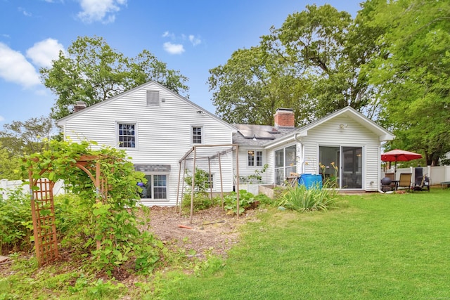 130 Olde Stage Rd, Glastonbury, CT 06033 - back of house featuring a chimney, a sunroom, and solar panels