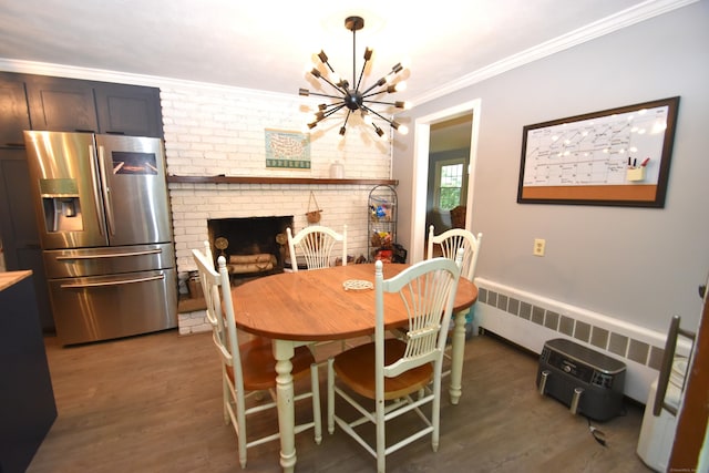 130 Olde Stage Rd, Glastonbury, CT 06033 - dining area with radiator heating unit, wood finished floors, a chandelier, crown molding, and a fireplace