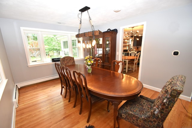 130 Olde Stage Rd, Glastonbury, CT 06033 - dining room with a chandelier, baseboard heating, and light wood-type flooring