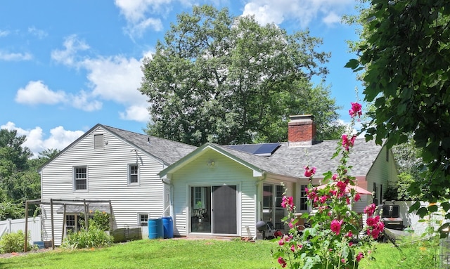 130 Olde Stage Rd, Glastonbury, CT 06033 - rear view of property featuring a chimney, roof with shingles, and solar panels