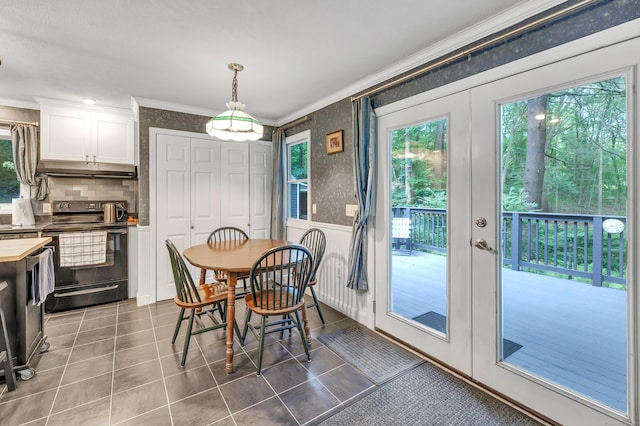 680 Wheelers Farms Rd, Milford, CT 06461 - dining room with healthy amount of natural light, crown molding, tile patterned floors, and wallpapered walls