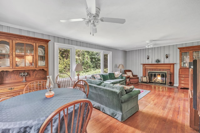 680 Wheelers Farms Rd, Milford, CT 06461 - living area featuring ceiling fan, crown molding, light wood-style floors, and a fireplace