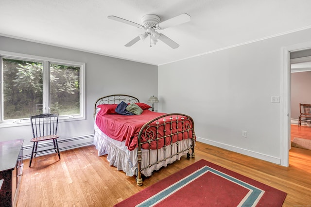 680 Wheelers Farms Rd, Milford, CT 06461 - bedroom with a baseboard heating unit, wood finished floors, ceiling fan, and ornamental molding