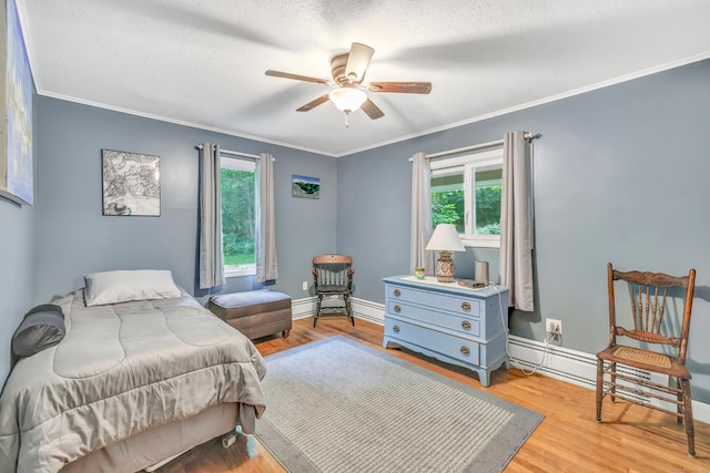 680 Wheelers Farms Rd, Milford, CT 06461 - bedroom with baseboard heating, crown molding, light wood-style flooring, a textured ceiling, and ceiling fan