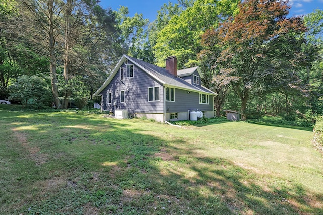 680 Wheelers Farms Rd, Milford, CT 06461 - view of property exterior featuring a lawn and a chimney