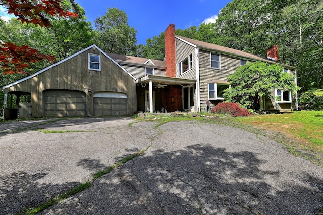 22 E Woods Rd, Roxbury, CT 06783 - view of front of house featuring a chimney, driveway, and a garage
