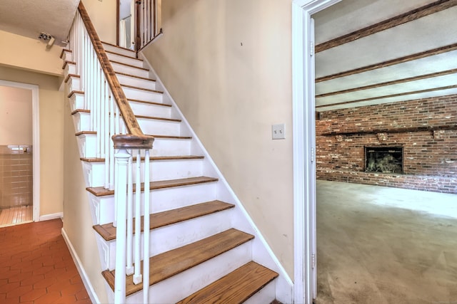 22 E Woods Rd, Roxbury, CT 06783 - stairway featuring a fireplace, tile patterned floors, and brick wall
