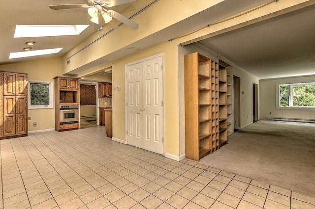 22 E Woods Rd, Roxbury, CT 06783 - unfurnished living room with a ceiling fan, a skylight, light tile patterned floors, a baseboard radiator, and light carpet