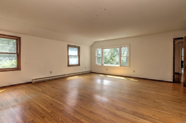 22 E Woods Rd, Roxbury, CT 06783 - spare room with baseboard heating, light wood-style flooring, and lofted ceiling