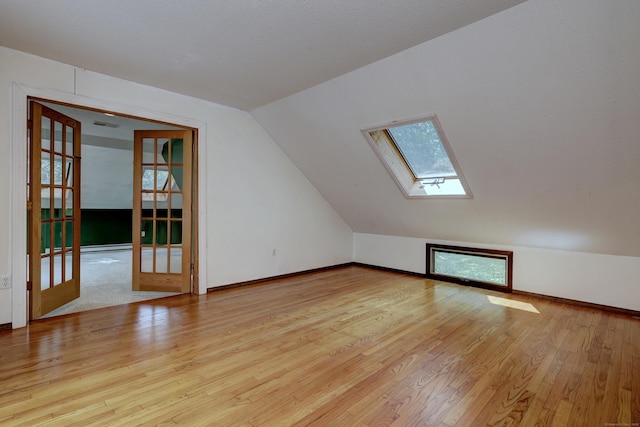 22 E Woods Rd, Roxbury, CT 06783 - bonus room featuring a skylight, french doors, wood finished floors, and lofted ceiling