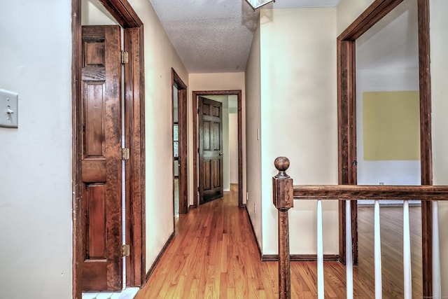 22 E Woods Rd, Roxbury, CT 06783 - hallway featuring an upstairs landing, light wood-type flooring, and a textured ceiling
