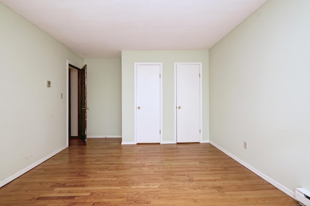 22 E Woods Rd, Roxbury, CT 06783 - unfurnished bedroom with light wood-type flooring and baseboard heating