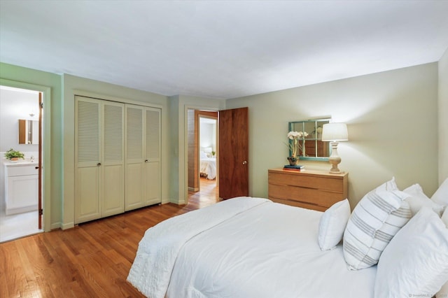 128 Carriage Dr, Avon, CT 06001 - bedroom with wood finished floors, connected bathroom, and a closet