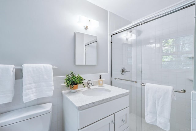 128 Carriage Dr, Avon, CT 06001 - full bath featuring tile walls, vanity, a stall shower, and a wainscoted wall
