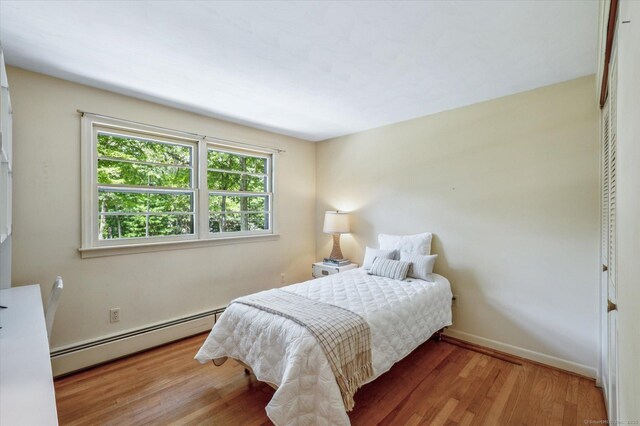 128 Carriage Dr, Avon, CT 06001 - bedroom with a baseboard radiator and wood finished floors