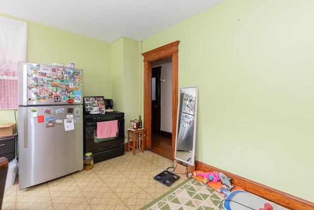 213 Easton Ave, Waterbury, CT 06704 - kitchen with freestanding refrigerator, black range with gas cooktop, and light flooring