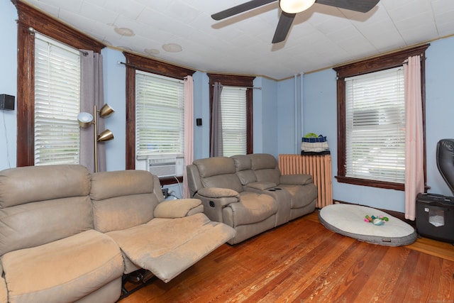 213 Easton Ave, Waterbury, CT 06704 - living area featuring ceiling fan, radiator, wood finished floors, and cooling unit