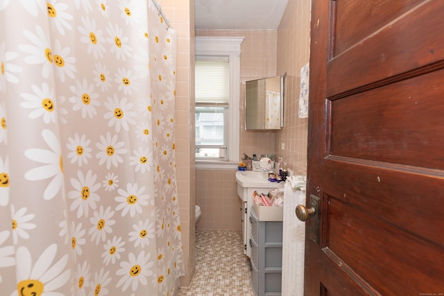 213 Easton Ave, Waterbury, CT 06704 - bathroom with tile walls, curtained shower, vanity, and tile patterned floors