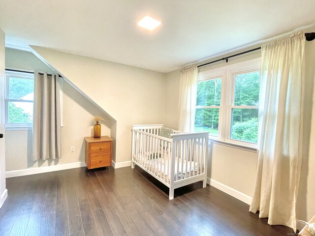 47 Chestnut Hill Rd, East Hampton, CT 06424 - bedroom featuring dark wood-style flooring, multiple windows, and a nursery area