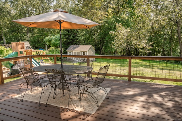 47 Chestnut Hill Rd, East Hampton, CT 06424 - deck with outdoor dining area, a shed, a playground, and view of wooded area