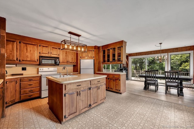 412 Goshen Rd, Litchfield, CT 06759 - kitchen with white appliances, light countertops, an island with sink, and brown cabinets