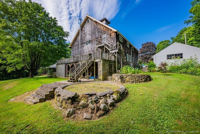 412 Goshen Rd, Litchfield, CT 06759 - back of property with stairway, a wooden deck, and a lawn