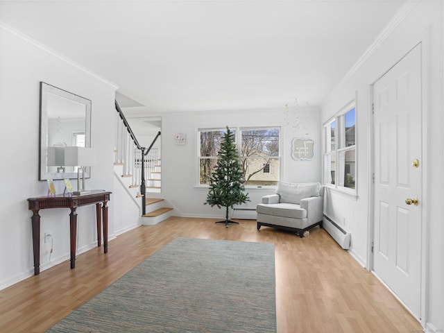 465 Edward St, Fairfield, CT 06824 - sitting room featuring light wood-style flooring, a baseboard radiator, stairs, and ornamental molding