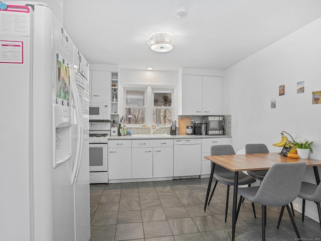 465 Edward St, Fairfield, CT 06824 - kitchen featuring white appliances, white cabinets, light countertops, and backsplash